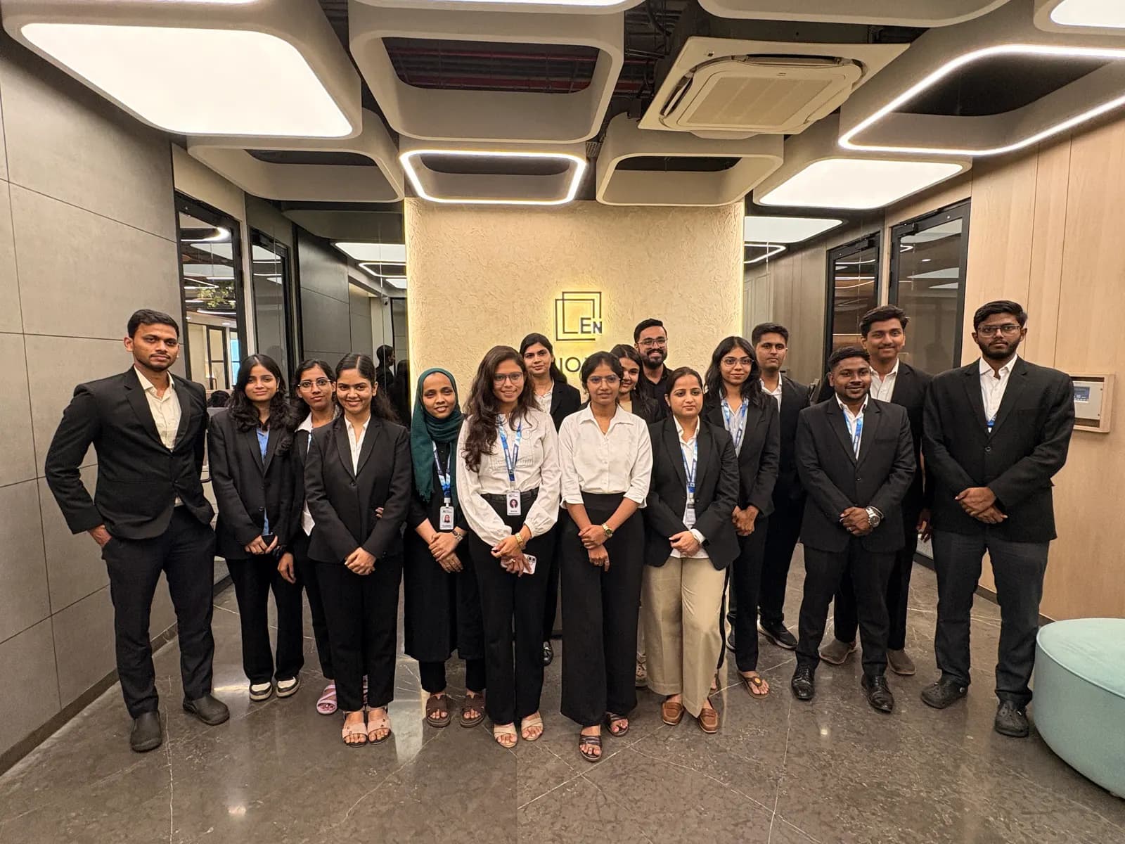 The team in formal business attire in the office lobby